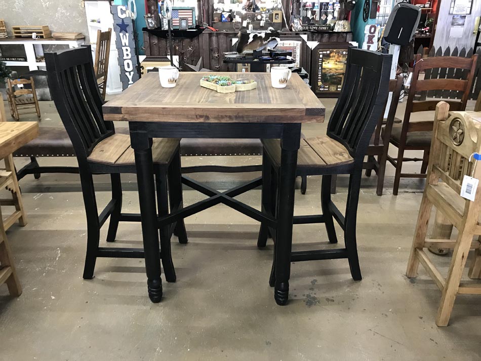 Rustic dining table set, with black turned legs, black chairs, and table top and chair seats in chestnut pine finish.