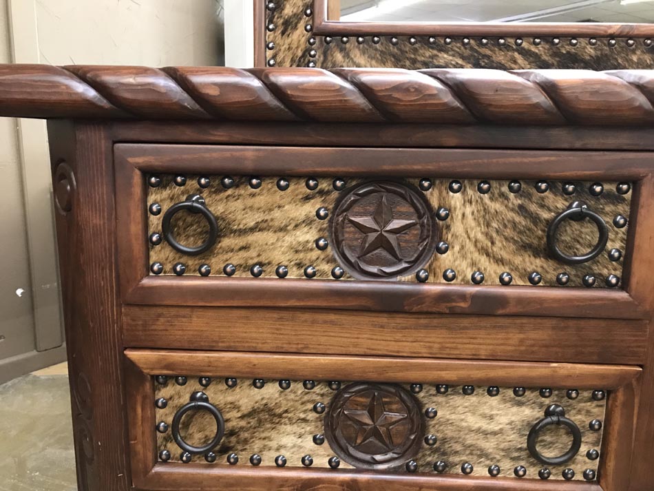Detail of lonestar dresser and mirror, with hide accents and deep, rich wood.