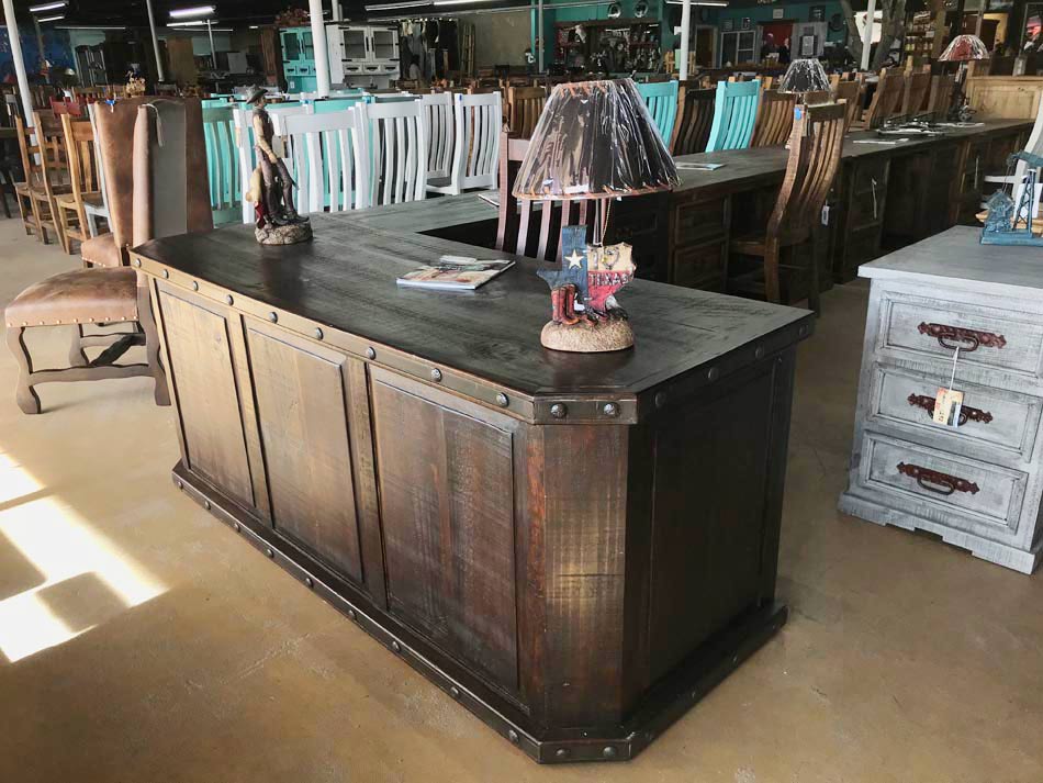 Alternate view of large dark-stained executive desk with rustic finish and brad accents.