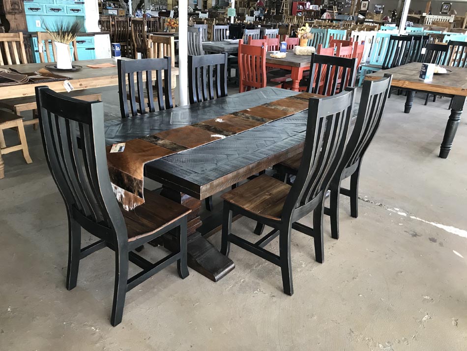 Beautiful dark rustic wood dining table, with plenty of room for up to 8 or more people; shown with chairs and table runner.